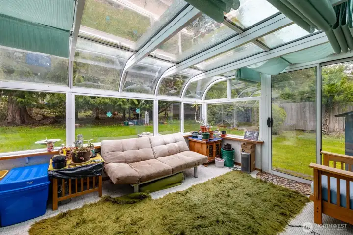 Bring the outdoors in throughout the seasons with this sunroom addition that is open to the private back yard
