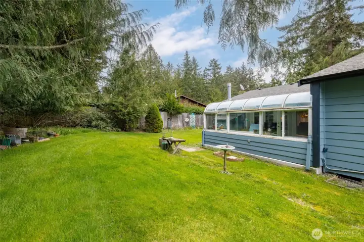The back yard is private and surrounded by greenery