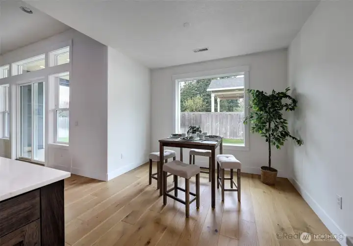 Dining area w/ view to backyard, and engineer hardwood floors