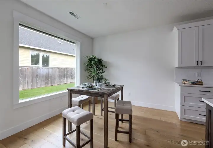 Dining area w/ view to backyard, and engineer hardwood floors