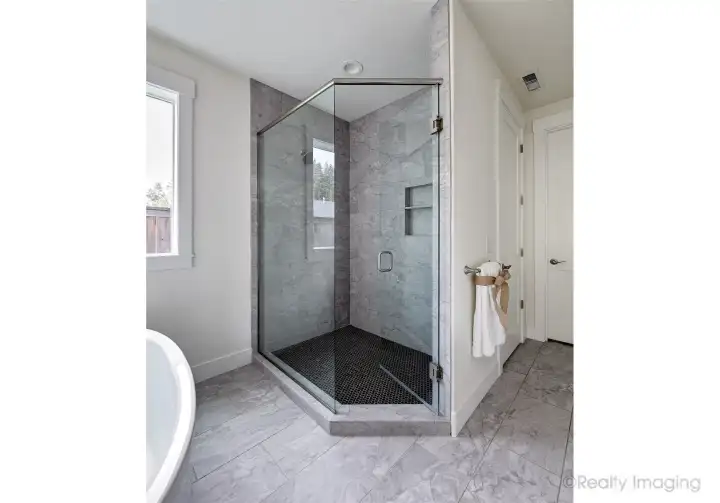Primary suite, walk-in tile shower w/ glass door, soaking tub, double quartz vanity