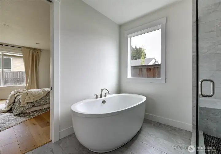 Primary suite, walk-in tile shower w/ glass door, soaking tub, double quartz vanity