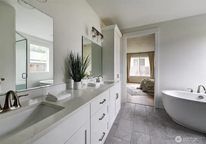 Primary suite, walk-in tile shower w/ glass door, soaking tub, double quartz vanity
