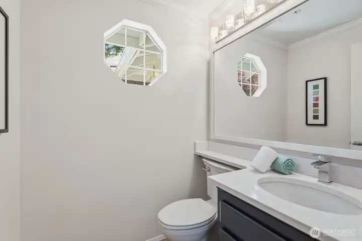Powder room with updated vanity and quartz counter