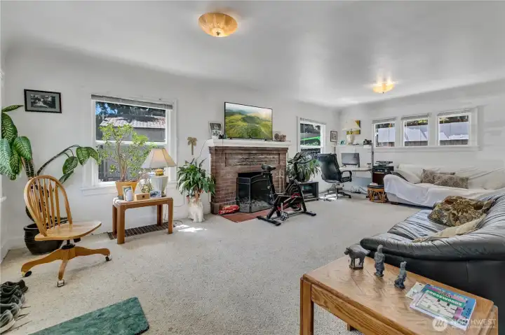 Entry into upper unit, main great room with vintage Cove ceilings and a wood burning fireplace. Entry into upper unit, main great room with vintage Cove ceilings and a wood burning fireplace.