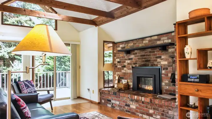 Vaulted ceilings, propane insert in fireplace alcove, double-sliders out to newly refurbished deck.