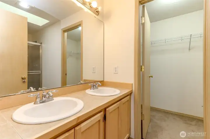 Primary bath with double sinks and walk in closet Primary bath with double sinks and walk in closet