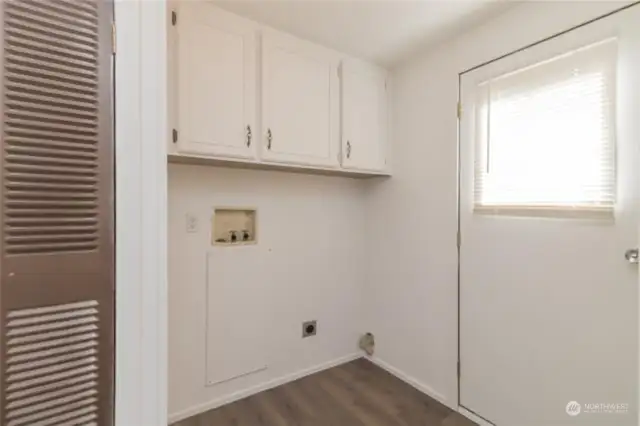 Laundry area with storage cabinets and furnace closet to left