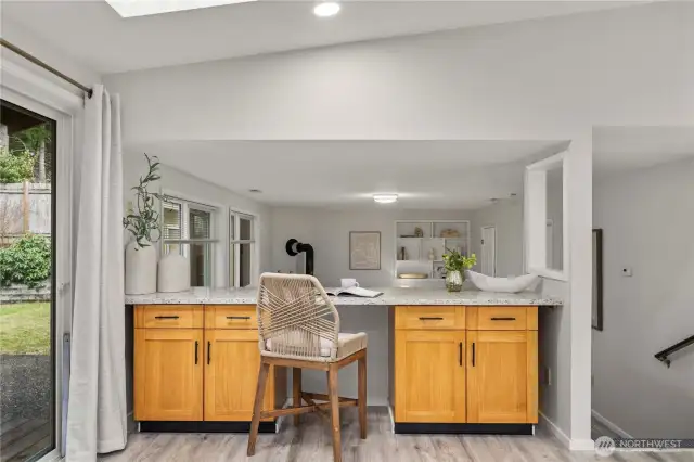 The convenient counter space between the kitche and the family room is perfect for an office/homework station, or beverage bar.