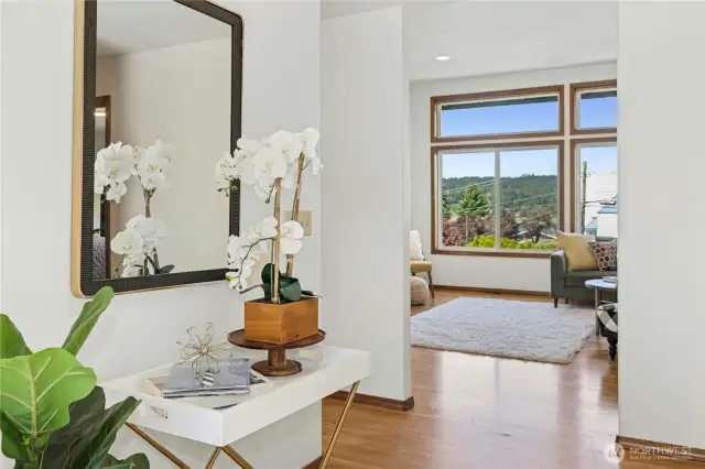 Welcoming entry with 10' high ceilings and hardwood floors