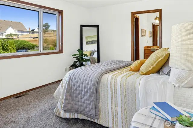 Primary bedroom with view of the First Lutheran church steeple, Liberty Bay & Olympic Mts.