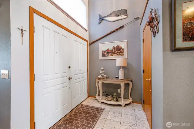 Main entrance from the rear parking lot with high ceilings greets you as you enter the oversized double doors