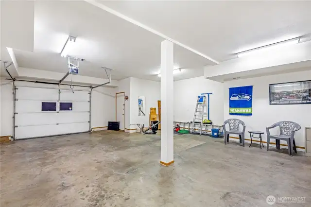 Expansive, single car garage with plenty of shop space.