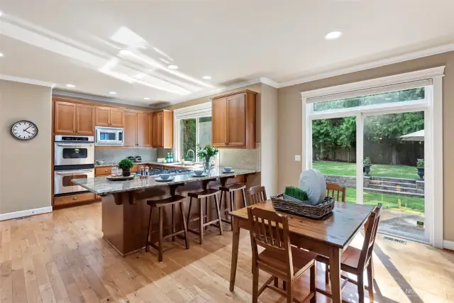 The kitchen overlooks the large backyard and patio and has a new refrigerator and dishwasher.