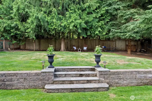 The fenced yard is adjacent to Duthie Hill Mountain Bike Park.  The evergreen trees provide year-round privacy.