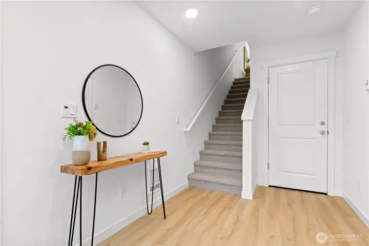 On entry, you will find your coat closet, main floor bedroom, and garage access  Lower floor guest bedroom/office