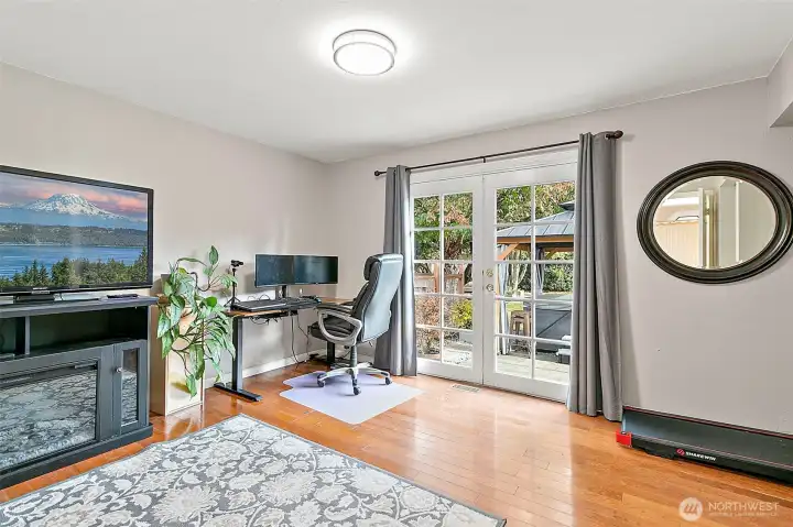 Bedroom #4 on lower level with French doors to patio.