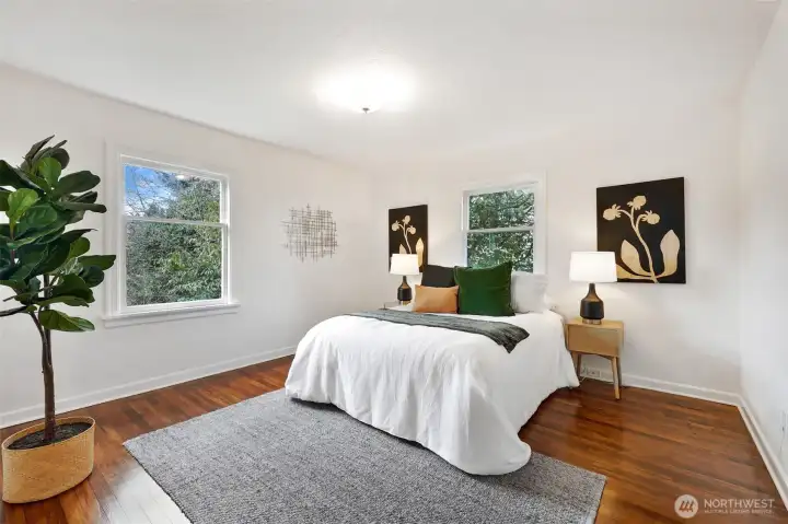 Spacious main floor bedroom overlooks lovely, landscaped backyard.