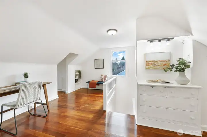 Second floor bonus room/landing with refinished wood floor and built-in drawers - a perfect office/sitting room.