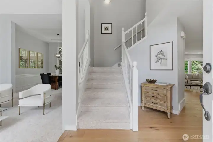 The entry foyer opens to bright living and dining rooms with vaulted ceilings and abundant natural light.