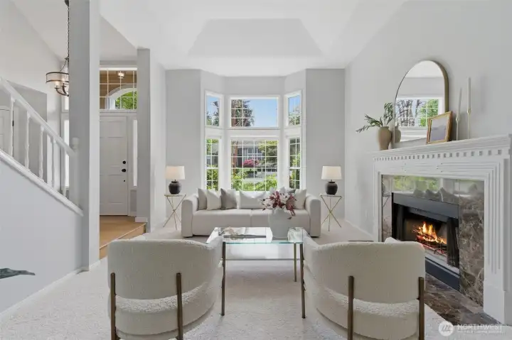 Elegant, light-filled living space with high ceilings and bay windows.