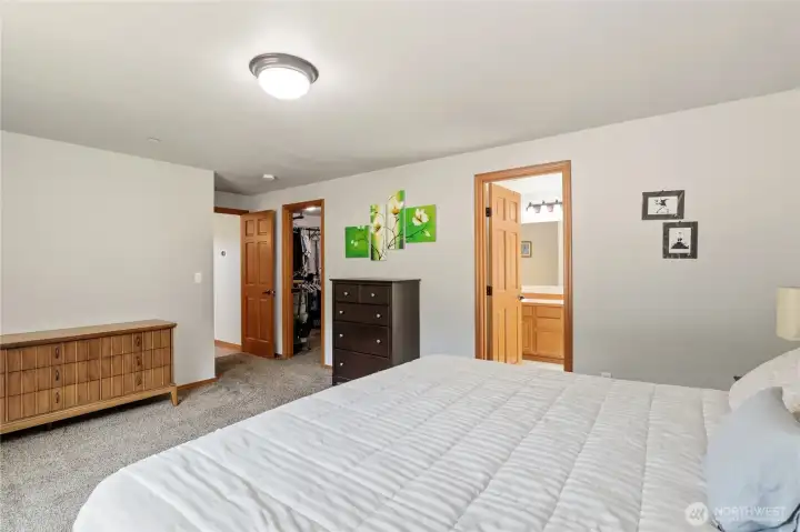 En suite primary bath and large walk-in closet in the main floor primary suite En suite primary bath and large walk-in closet in the main floor primary suite