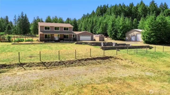 View of the buildings from the pasture/outdoor arena. View of the buildings from the pasture/outdoor arena.
