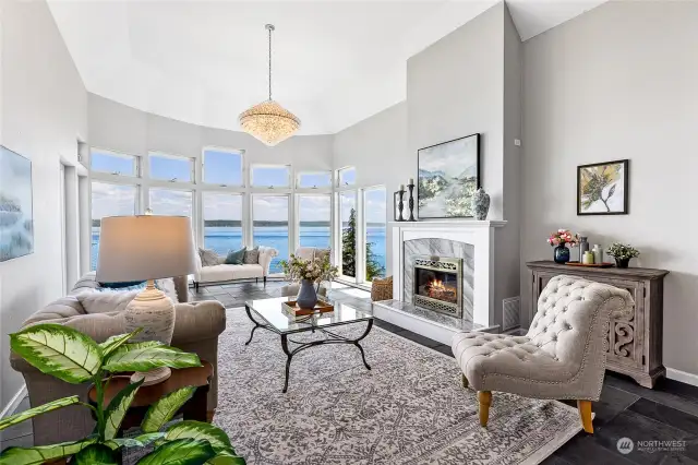 Floor to ceiling bay windows capture the water views from every seat in the living room.