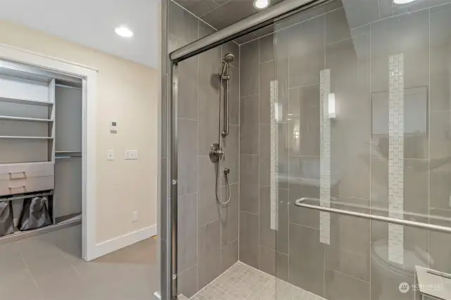 Tile walk-in shower in Primary en-suite bathroom.