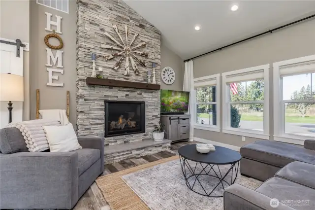 Living room with a gorgeous gas fireplace and floor-to-ceiling brickwork