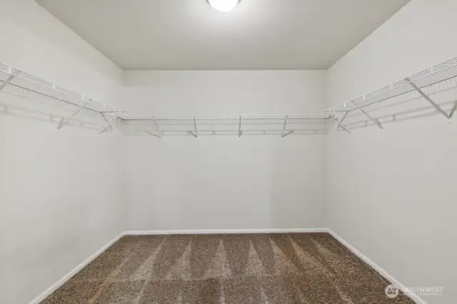 Primary Walk-In Closet-Disclaimer- Photos are of another Warren-2448 floor plan from a previous community, photos are for illustrative purposes only. Finishes, flooring, upgrades, or other features may vary.