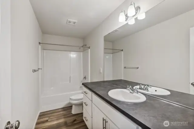 2nd full bath upstairs-Disclaimer- Photos are of another Warren-2448 floor plan from a previous community, photos are for illustrative purposes only. Finishes, flooring, upgrades, or other features may vary.