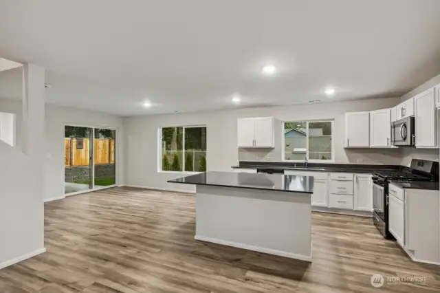 Open Concept Living/Dining Kitchen-Disclaimer- Photos are of another Warren-2448 floor plan from a previous community, photos are for illustrative purposes only. Finishes, flooring, upgrades, or other features may vary.