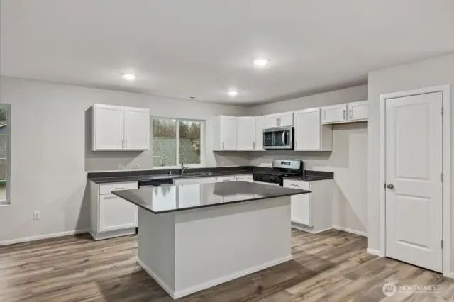 Open Concept Living/Dining Kitchen-Disclaimer- Photos are of another Warren-2448 floor plan from a previous community, photos are for illustrative purposes only. Finishes, flooring, upgrades, or other features may vary.