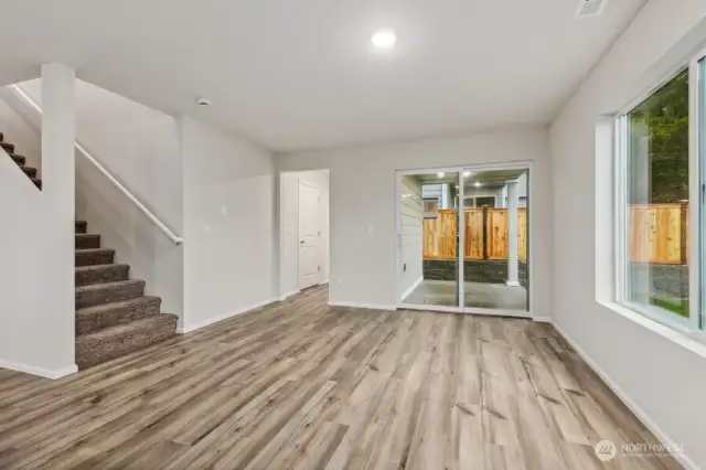 Open Concept Living/Dining Kitchen-Disclaimer- Photos are of another Warren-2448 floor plan from a previous community, photos are for illustrative purposes only. Finishes, flooring, upgrades, or other features may vary.