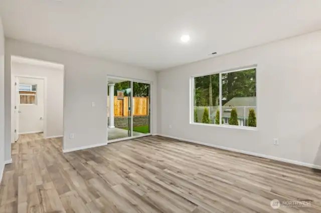 Open Concept Living/Dining Kitchen-Disclaimer- Photos are of another Warren-2448 floor plan from a previous community, photos are for illustrative purposes only. Finishes, flooring, upgrades, or other features may vary.