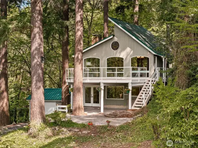 This thoughtfully designed custom home offers a large outdoor deck and a durable metal roof.