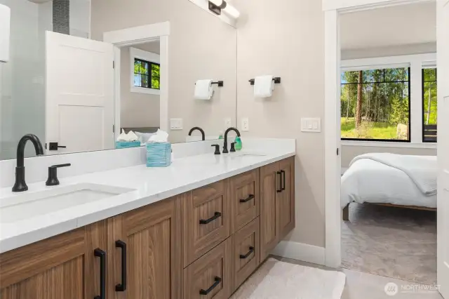 Dual vanity and walk-in shower in the primary suite.