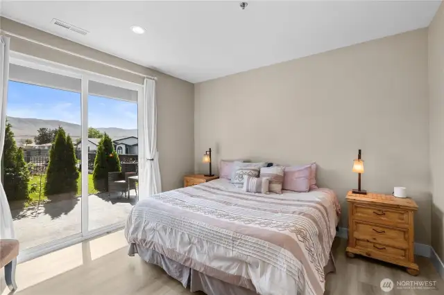 Bedroom 1 with sliding glass doors to front porch.