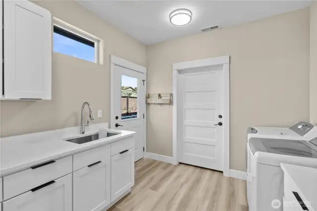 Huge laundry room with Quartz countertops.