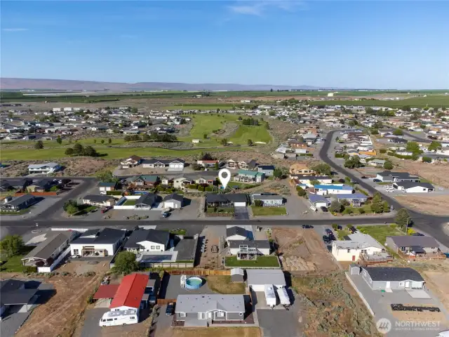 Aerial view of home facing golf course.