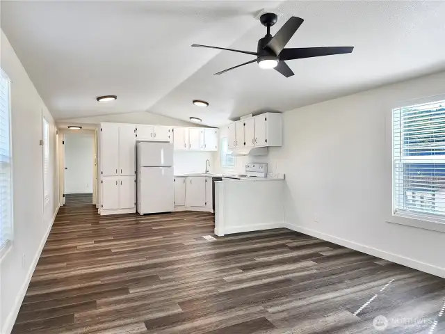 Light-filled living space with a fresh modern finishes. Updated light fixtures and window blinds.