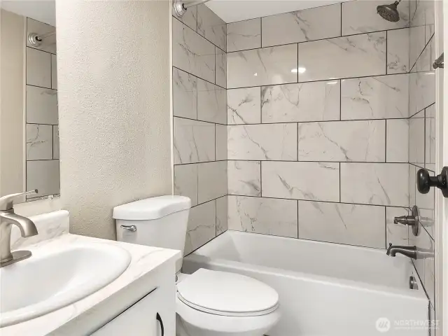 Updated main bathroom with fresh finishes and full tub/shower