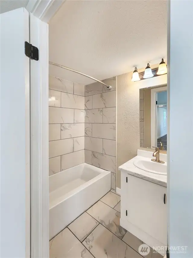 Full bath in primary suite with modern updates.