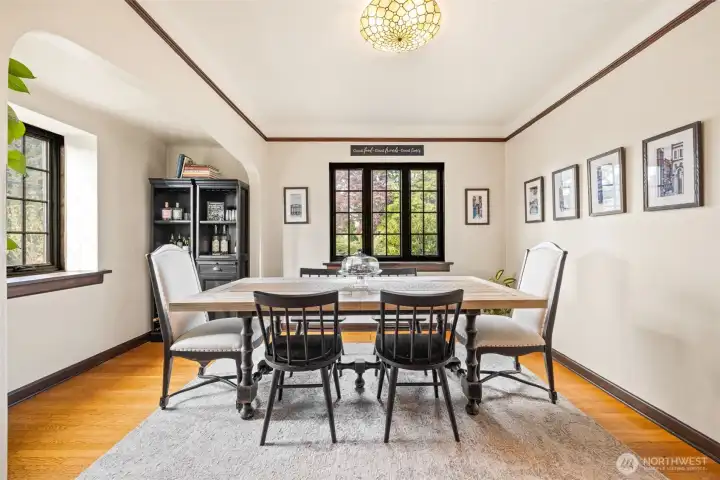 Spacious dining room with charming archways and plenty of natural light.