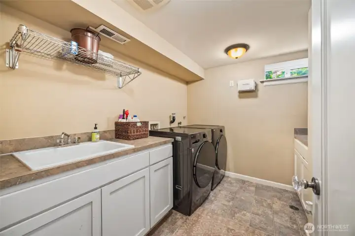 Spacious laundry and additional storage.