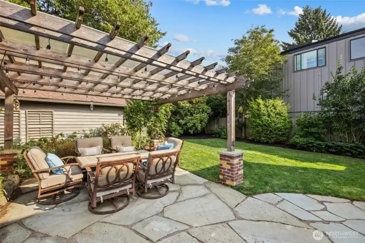 This backyard is designed in a casual, outdoor living style with traditional elements and beautiful landscape design.