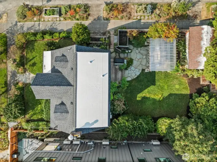 Well-maintained Tudor surrounded by lush landscape, garden beds and entertainment areas or for relaxation.