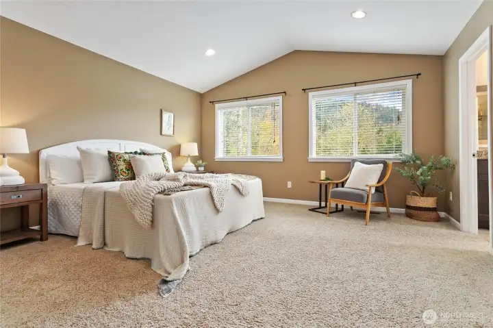 Vaulted ceilings continue in the primary suite.