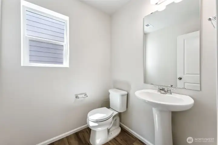 1/2 bath on Main-Disclaimer- Photos are from a similar floor plan from another community, photos are for illustrative purposes only. Finishes, flooring, features, upgrades, countertops, paint, colors, and other features may vary.